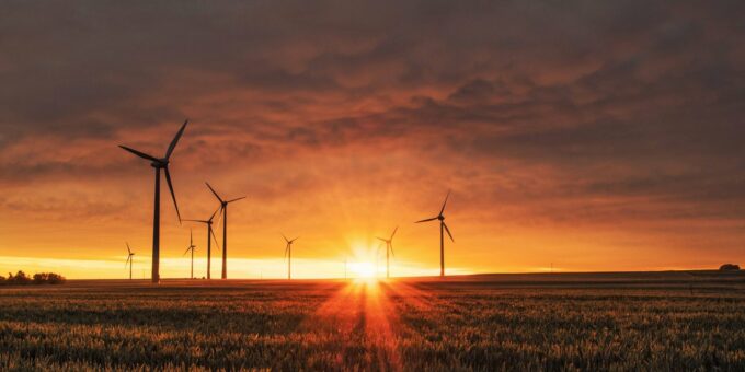 windmill on grass field during golden hour